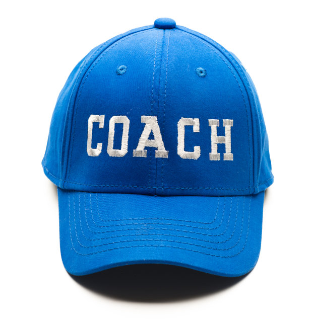 A baseball cap saying Coach